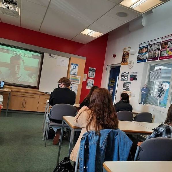 Politics classroom showing students watching Andy Burnham on screen at the front of the class.